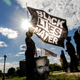 A woman holds a Black Lives Matter flag during an event in remembrance of George Floyd and to call for justice for those who lost loved ones to the police violence outside the Minnesota State Capitol on May 24, 2021 in Saint Paul, Minnesota.